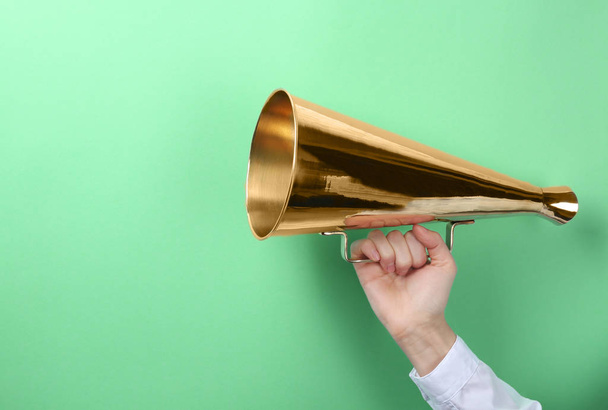 Woman holding megaphone on color background - Photo, image