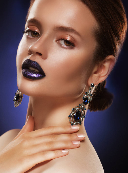 Fashion portrait of young beautiful woman with jewelry. Perfect make-up. Blue lips. - Photo, Image