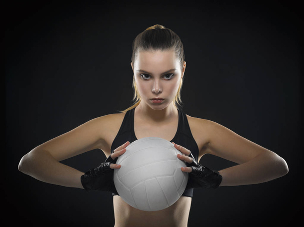 Beautiful young girl athlete in a black top with an aggressive p - Photo, Image