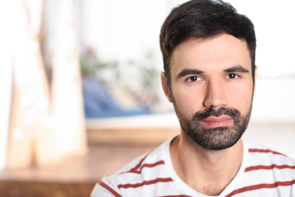 Young bearded man in casual clothes indoors - Foto, immagini