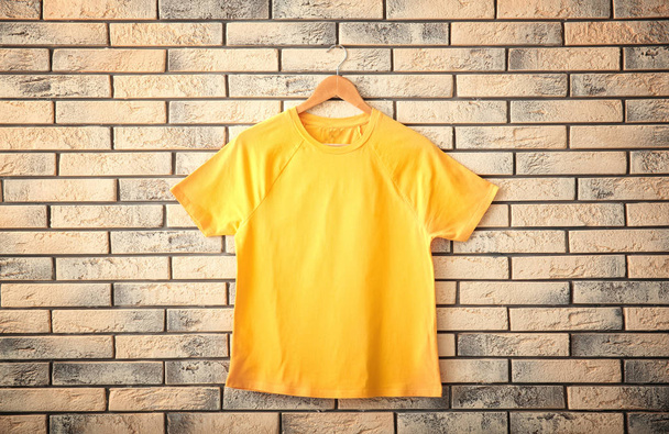 Color t-shirt on brick wall background. Mockup for design - Zdjęcie, obraz