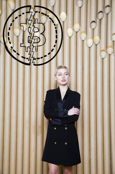 Beautiful blond woman showing standing near bitcoin sketch. Virtual money or btc crush concept. Cryptocurrency. - Fotoğraf, Görsel