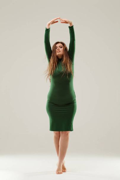 Beautiful large girl isolated in green dress - Zdjęcie, obraz
