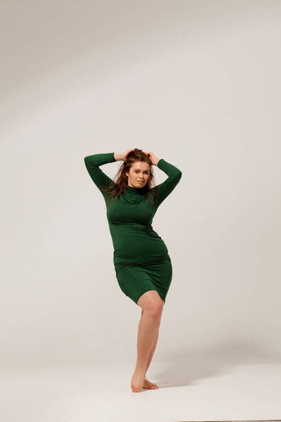 Beautiful large girl isolated in green dress - Photo, Image