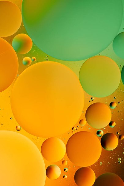 Mixing water and oil, beautiful color abstract background based on red and yellow circles and ovals, macro abstraction - Photo, image