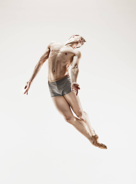 The male athletic ballet dancer performing dance isolated on white background. - Φωτογραφία, εικόνα