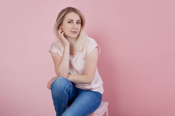 Calm and gentle portrait of a young woman on pink background. - Foto, Imagem