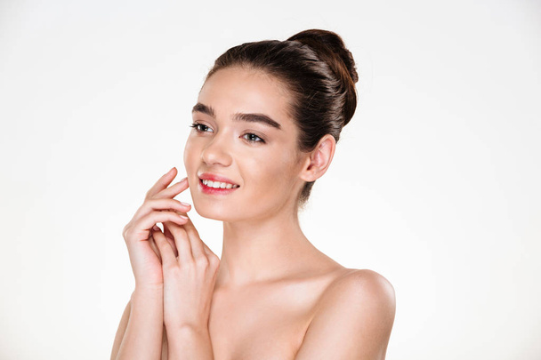 Image of brunette female with hair in bun and natural makeup smi - Fotoğraf, Görsel