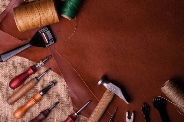 top view of leather craft tools on burlap surface - Photo, Image