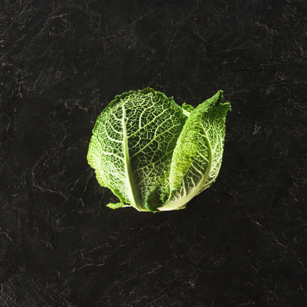 top view of fresh healthy organic savoy cabbage on black   - Photo, Image