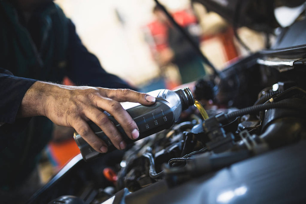 Car service mechanic working on automobile engine repair - Photo, Image