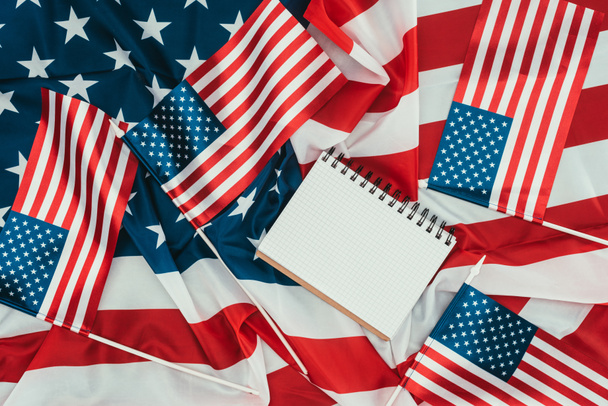 top view of arranged american flags and blank notebook, presidents day concept - Foto, Imagen