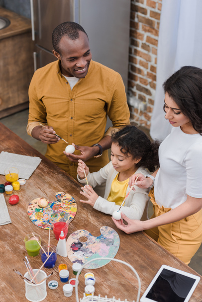 high angle view of african american family painting easter eggs - Foto, imagen