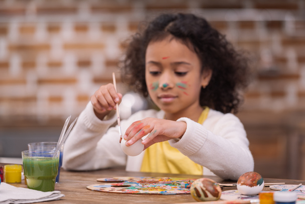african american kid painting easter egg - Foto, immagini