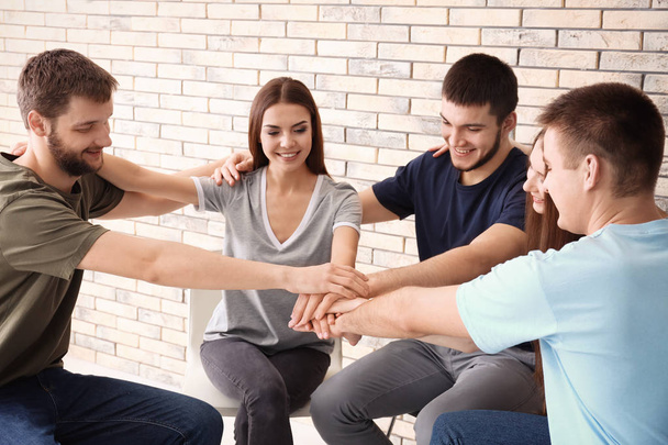 People putting hands together, indoors. Unity concept - Φωτογραφία, εικόνα