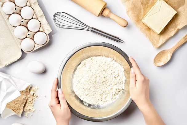 Hand sift flour. Bakery prepare for make cake. Top view - Fotó, kép