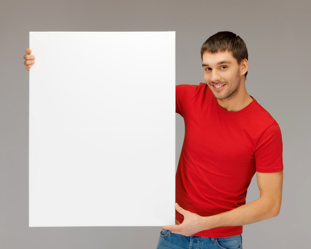 Handsome man with big blank board - Фото, изображение