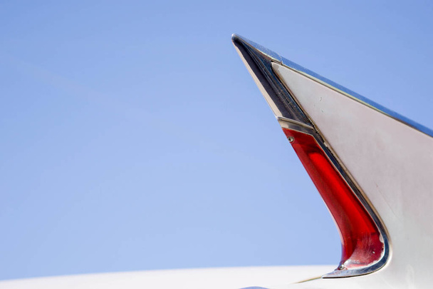 tailfin and tail light of a classic car under a clear blue sky - Photo, Image