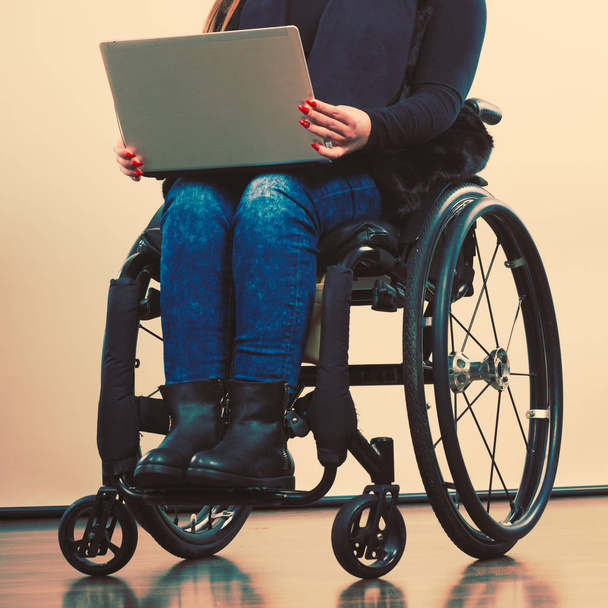 Disabled woman with laptop on wheelchair. - Zdjęcie, obraz