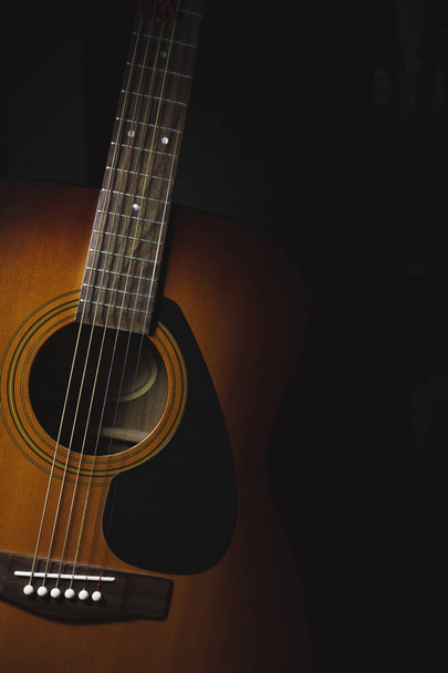 Acoustic guitar on a dark background - Photo, Image