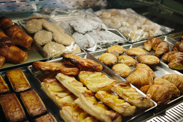 Assortment of tasty sweet bakery on case in the shop. - Foto, Imagem