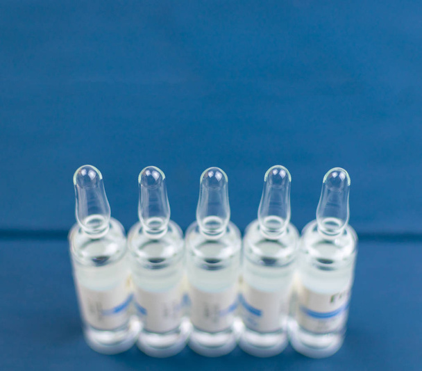 Medical ampoules on a blue background. - Photo, image