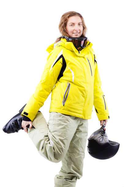 female skier with helmet in yellow jacket - Foto, afbeelding