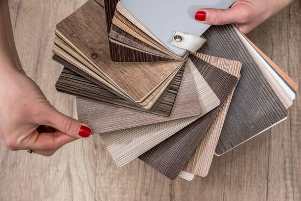 women showing Samples of laminate and vinyl floor tile - Photo, Image