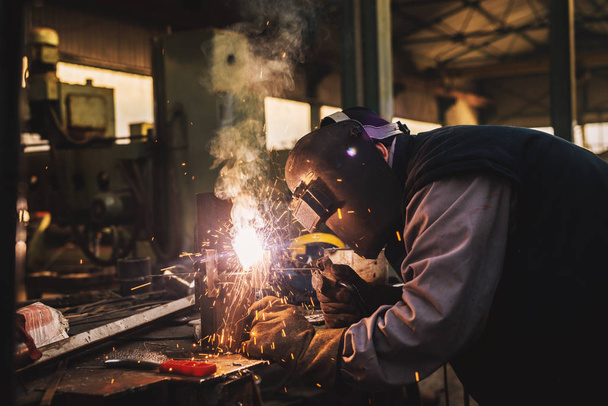  professional welder with protection mask working in workshop - Photo, Image