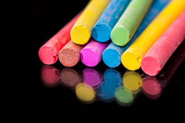 Group of colored chalk to draw isolated on black. - Photo, Image