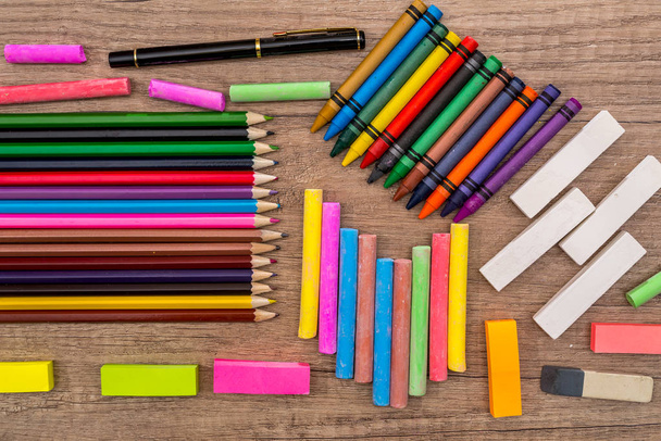 School Supplies - colored chalks and  pencils on a wooden background. - Fotografie, Obrázek