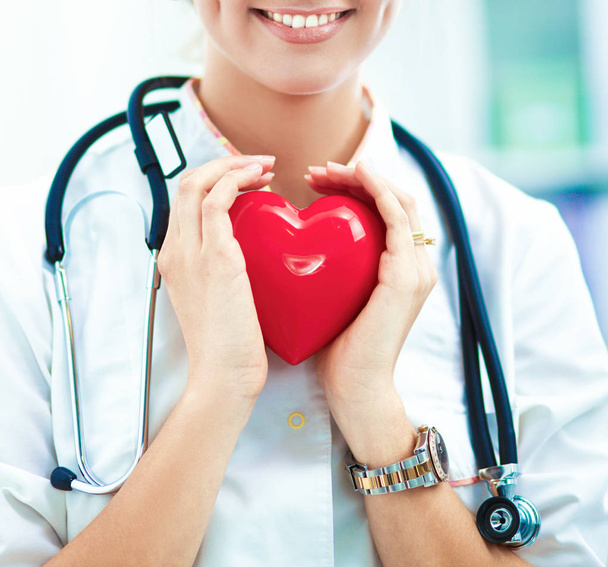 Doctor with stethoscope holding heart, isolated on white  background - Foto, Imagem