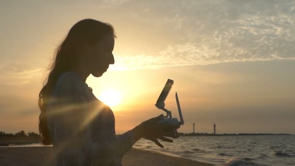 Bella donna mantiene un pannello drone al tramonto in slo-mo
 - Filmati, video