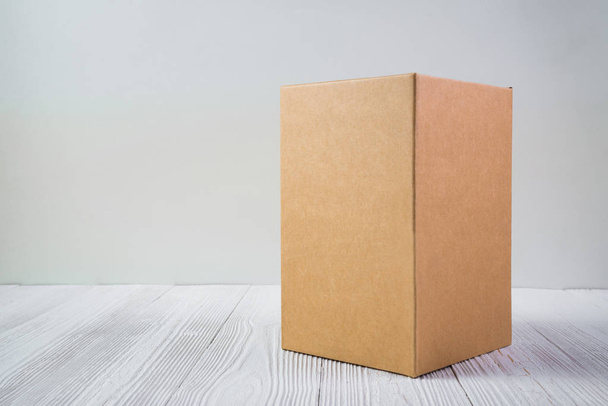 Empty Package brown cardboard box or tray on bright wooden table - Φωτογραφία, εικόνα