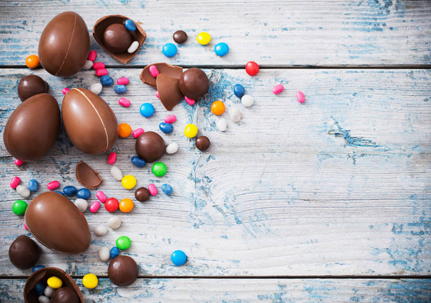 Chocolate Easter Eggs Over Wooden Background - 写真・画像