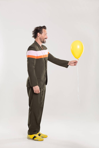 Happy man with yellow balloon - Zdjęcie, obraz