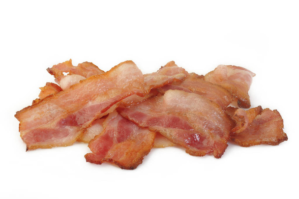 Cooked bacon rashers on a white background - Photo, Image