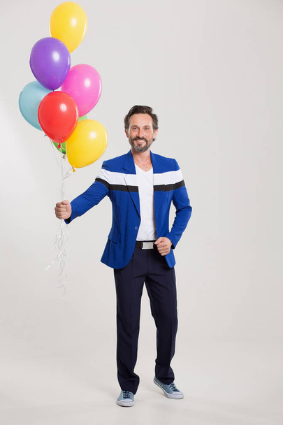 Funny harlecuin with balloons - Foto, Imagem