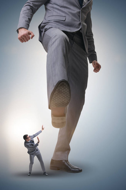 Bad angry boss kicking employee in business concept - Photo, Image