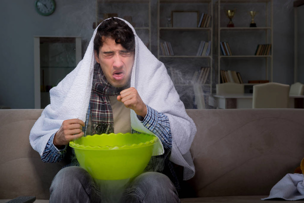 Sick man doing inhalation at night in home - Photo, Image