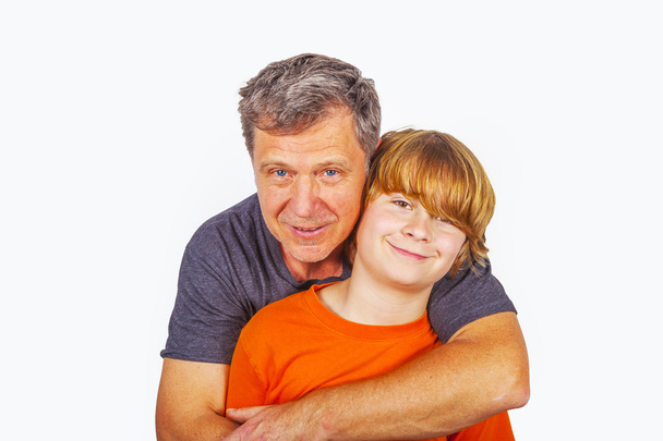 father and son hugging in studio isolated on white - Photo, Image