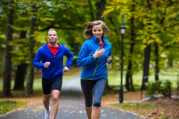 Healthy lifestyle - woman and man running in park - Fotoğraf, Görsel