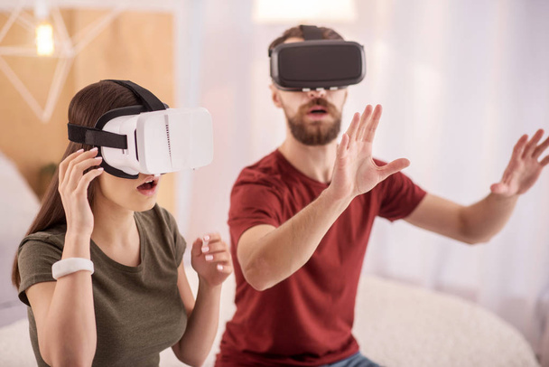 Positive attractive couple exploring VR - Foto, afbeelding