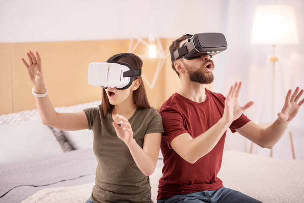 Astonished pretty couple seeing virtual world - Foto, imagen