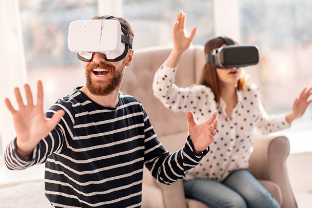 Joyful merry man shifting through VR world - Фото, зображення