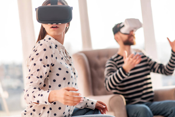 Stricken surprised woman adjusting to VR - Foto, Bild