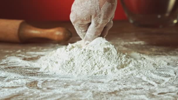 baker hand preparing flour on the table to make dough slow motion - Footage, Video
