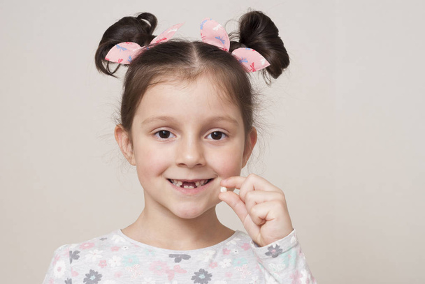little girl and a milk tooth - Photo, Image