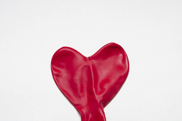 Heart shape red deflate ballon against white background. Valentine's Day - Фото, зображення
