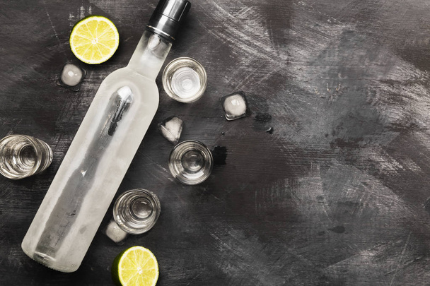 Cold vodka in shot glasses on a black background. Top view, copy - Foto, Imagem